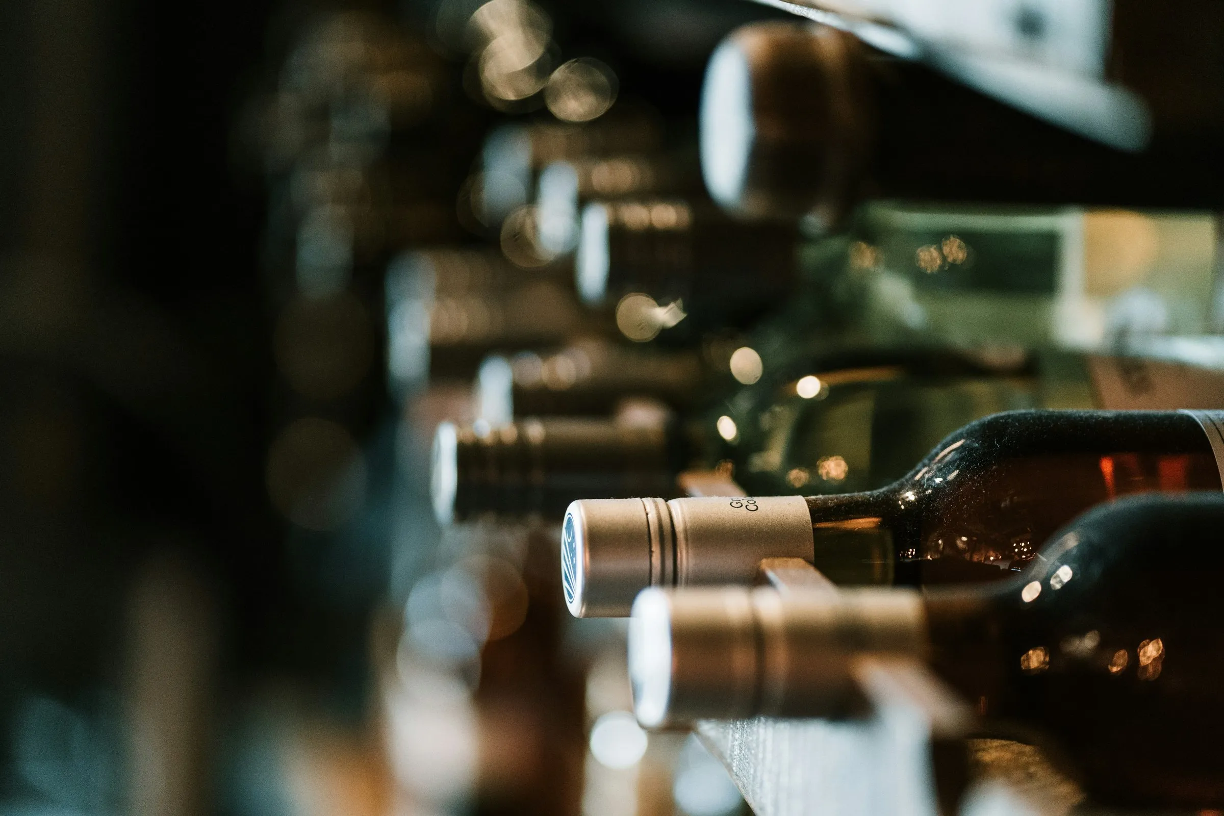 Wine bottles stacked on wooden shelves